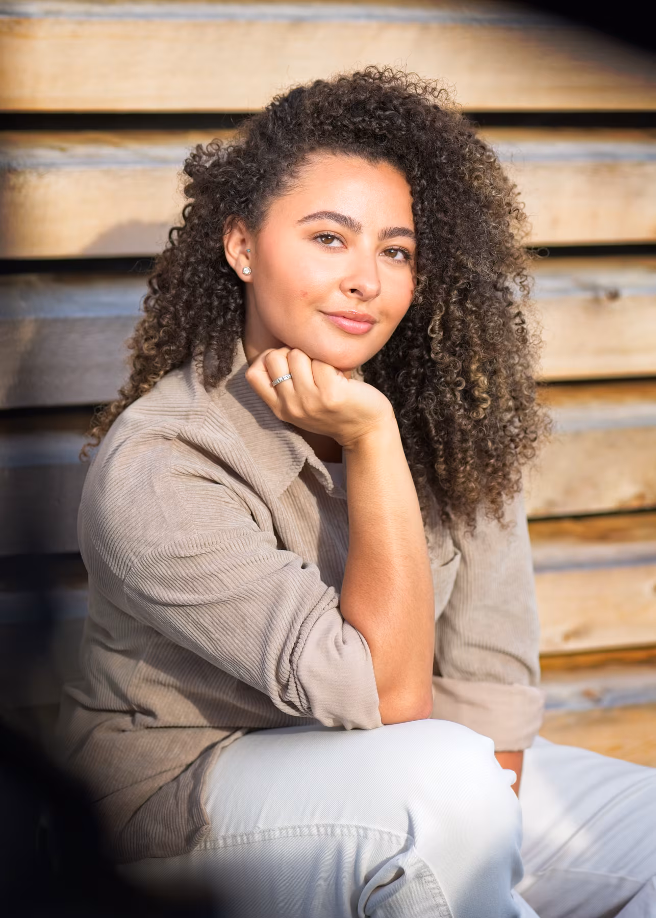 Seated indoor portrait by a large window